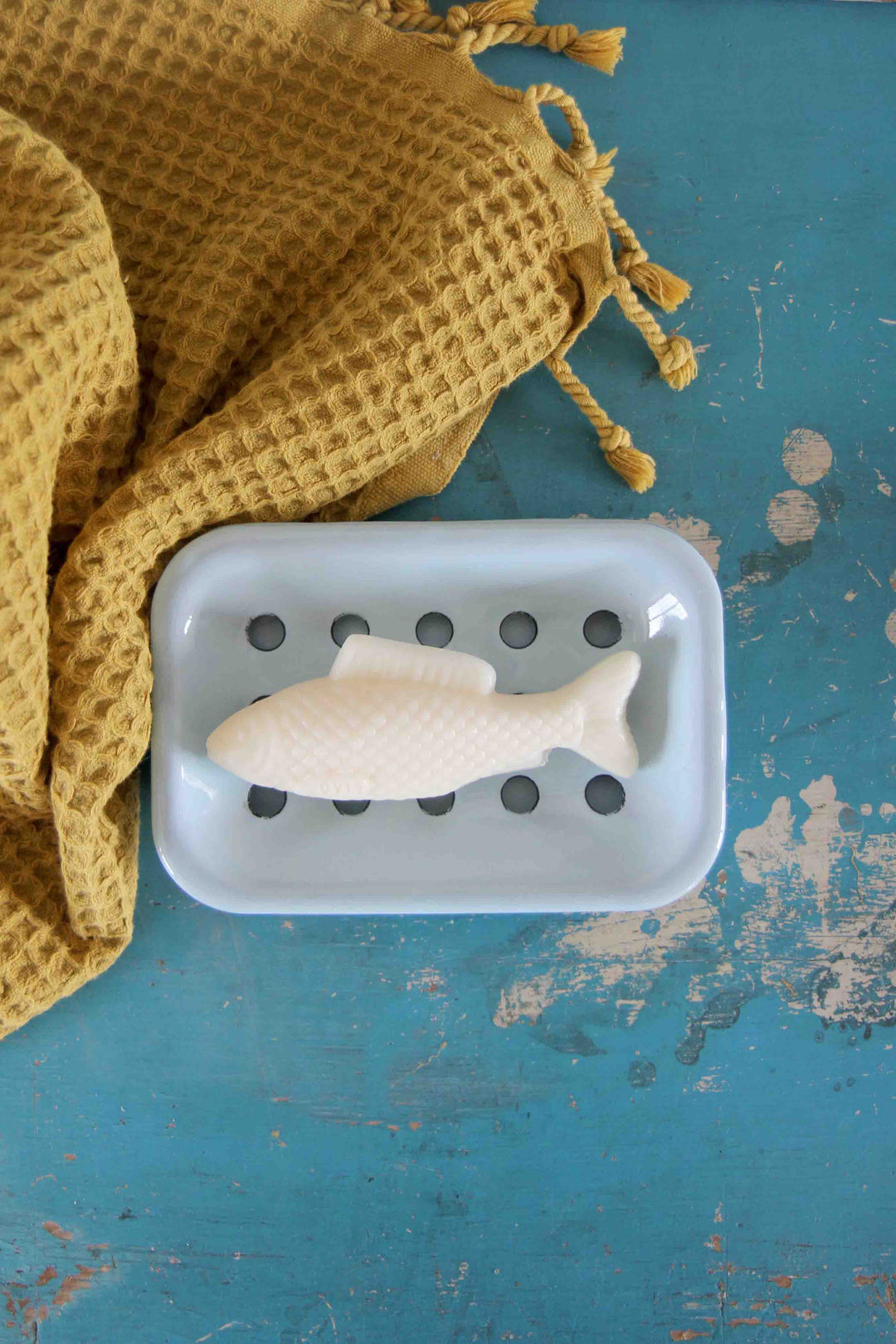 fish soap on enamel soap dish with mustard waffle towel