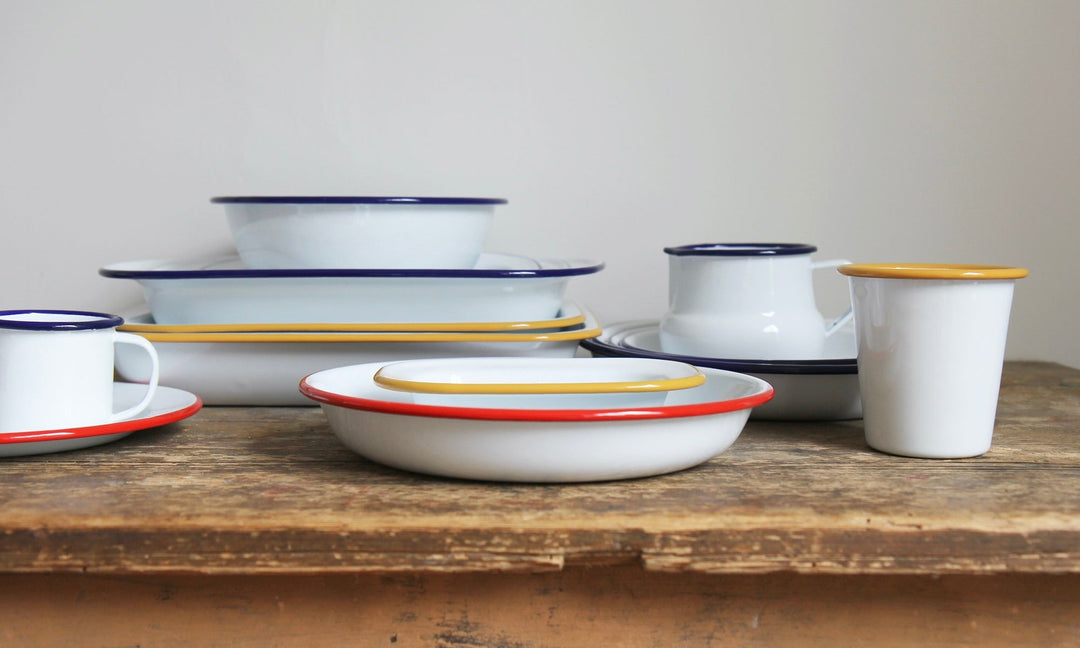 stack of classic white enamelware, bowls and tumblers