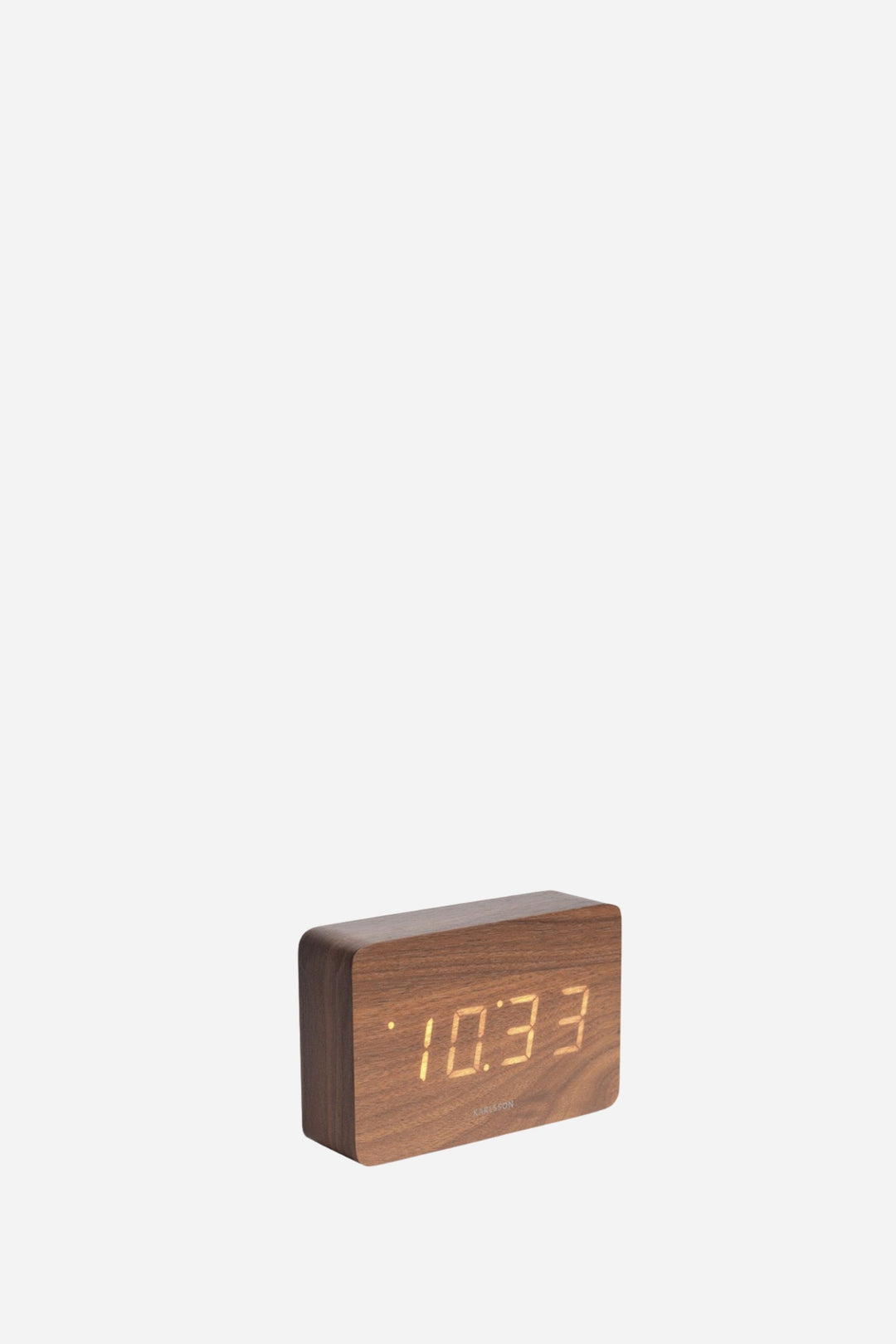 Brown LED alarm clock in front of white back round