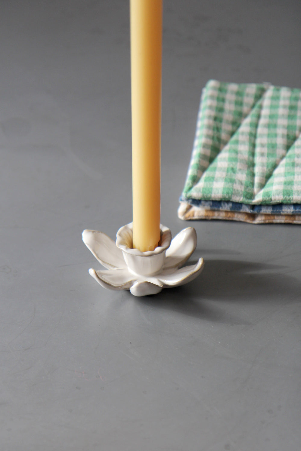 daffodil candle holder in cream with yellow dinner candle