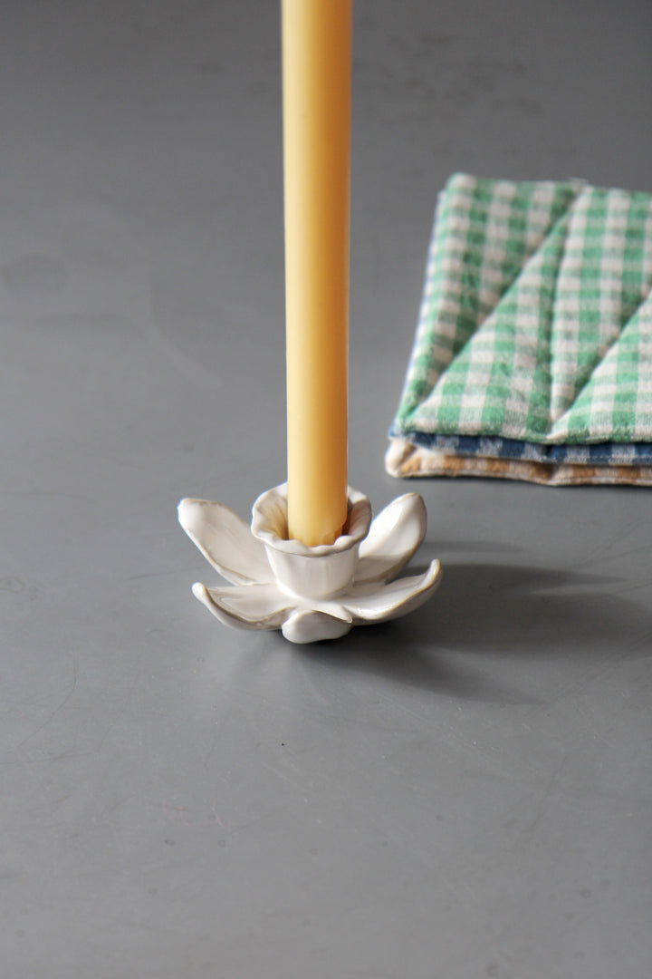 daffodil candle holder in cream with yellow dinner candle