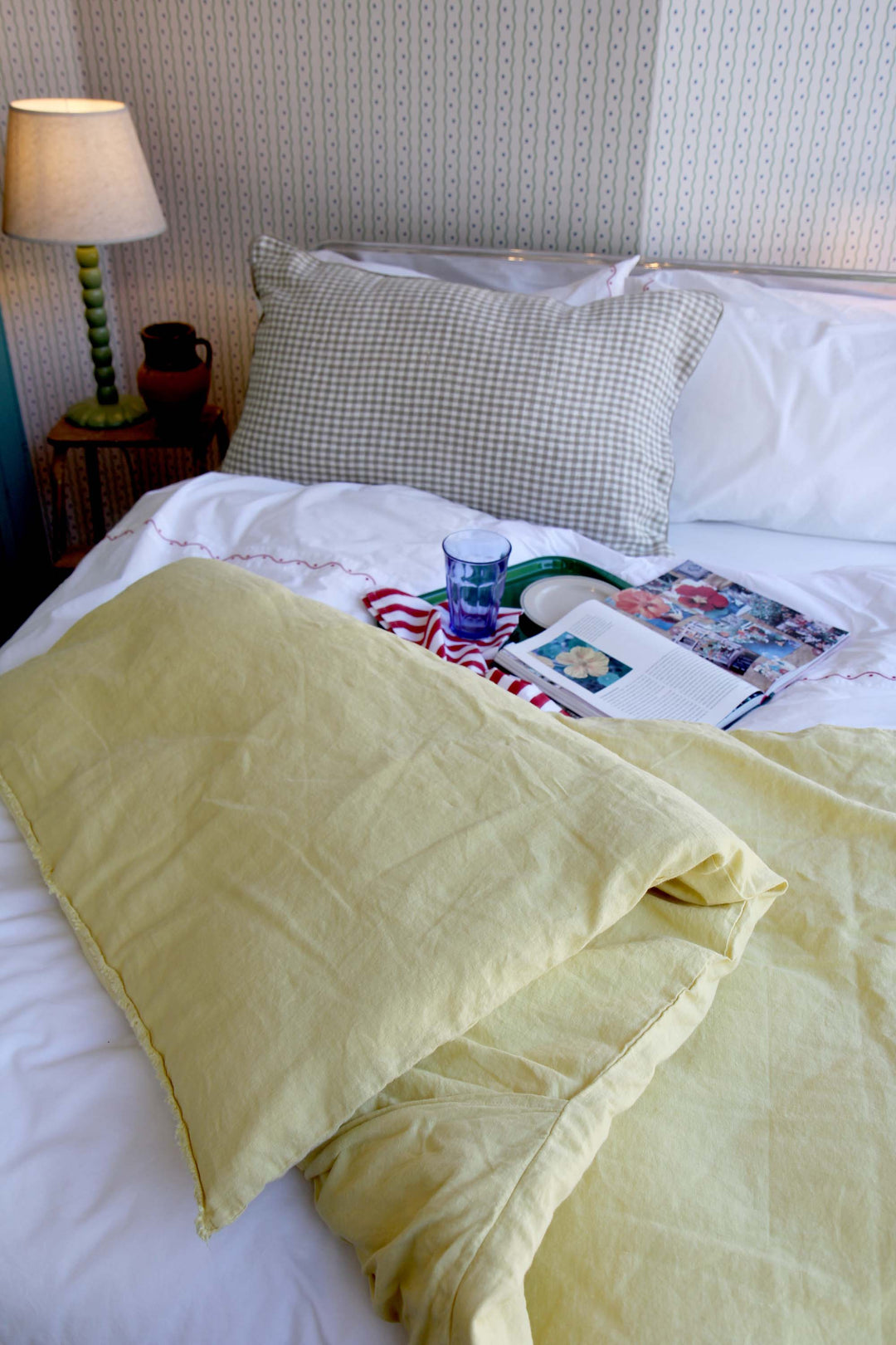 limy quilt in paille yellow linen on bed