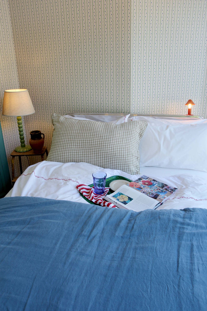 limy linen quilt on bed in turquin blue