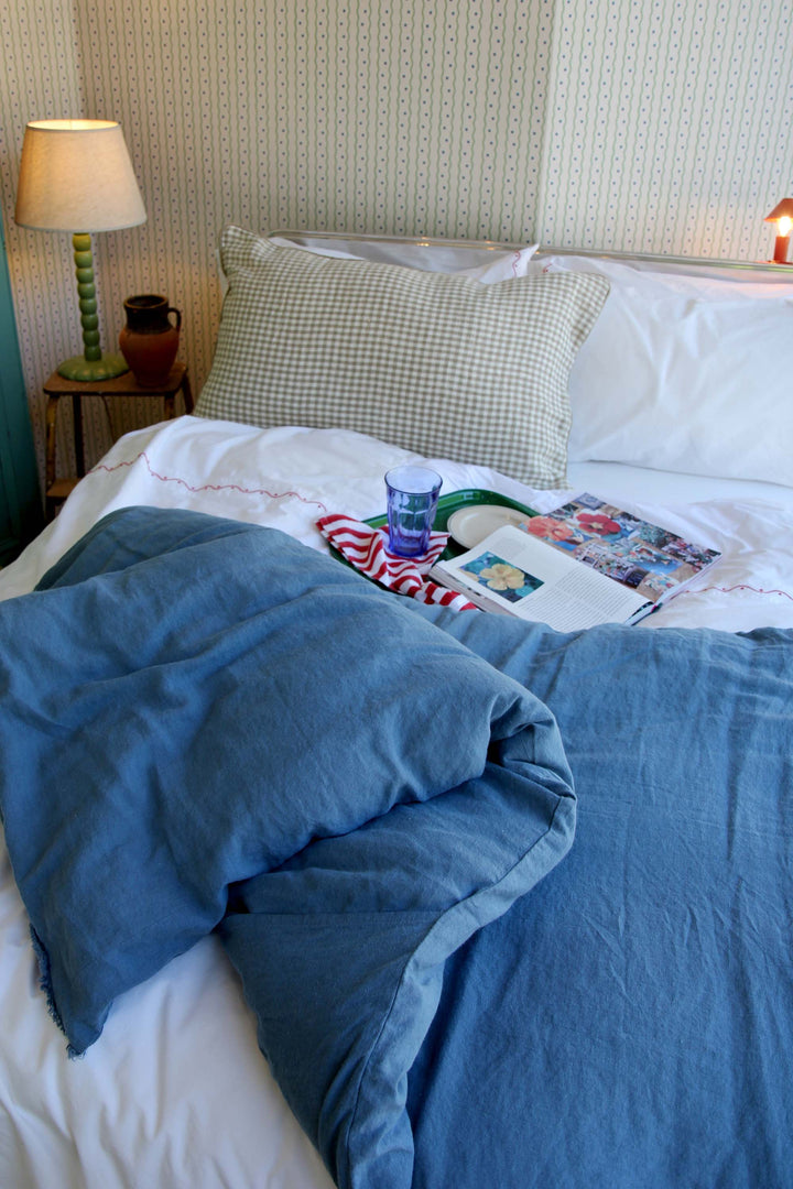 ruffled limy quilt in turquin linen on bed