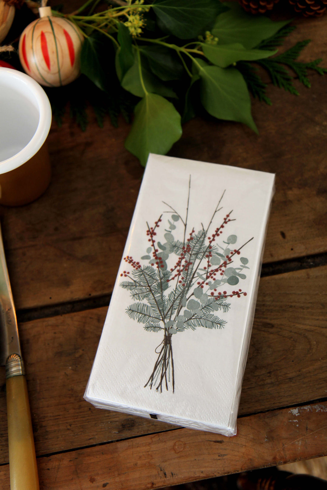 Paper napkins with botanical design on a wooden surface