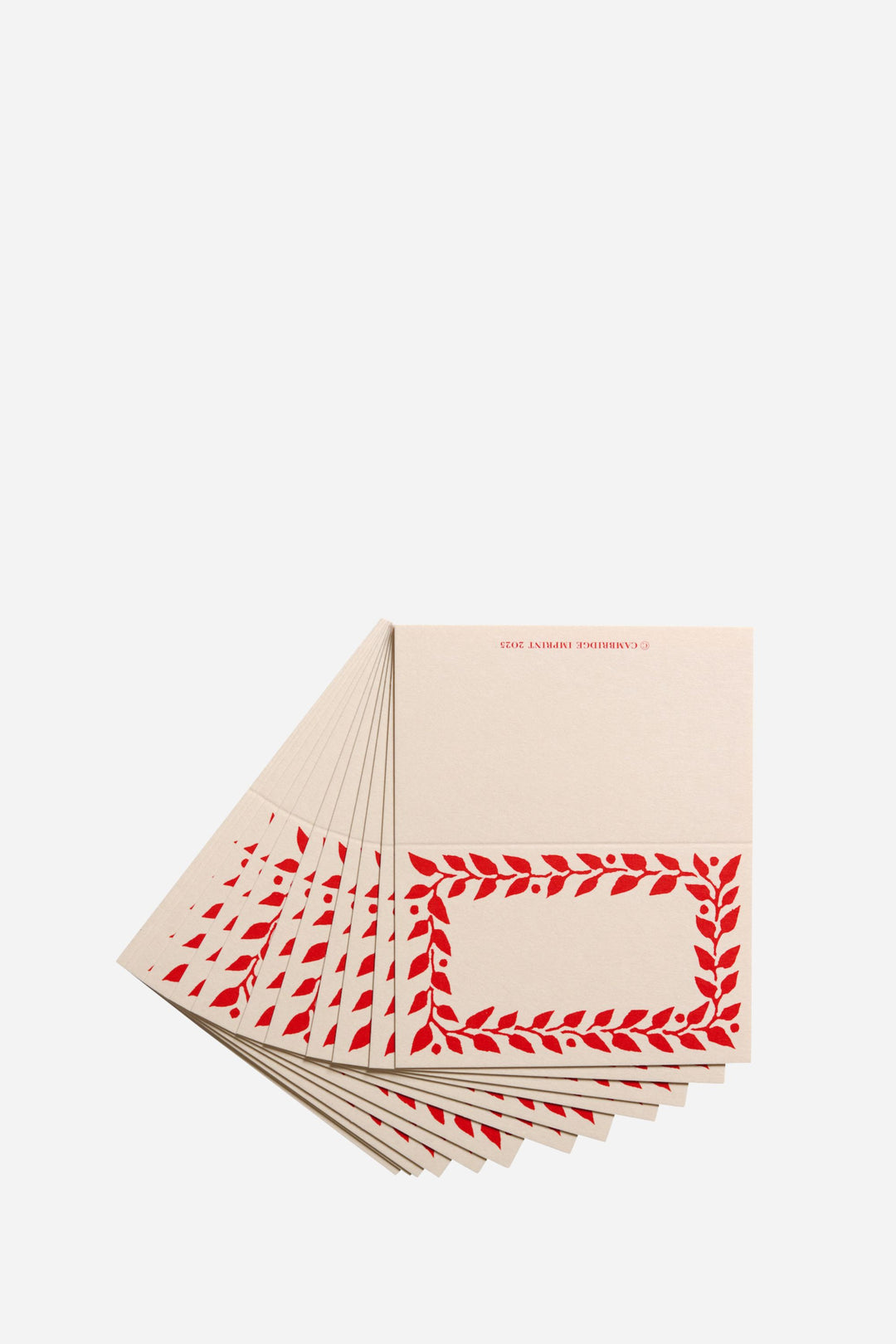 Stack of beige cards with red leaf pattern on a white background