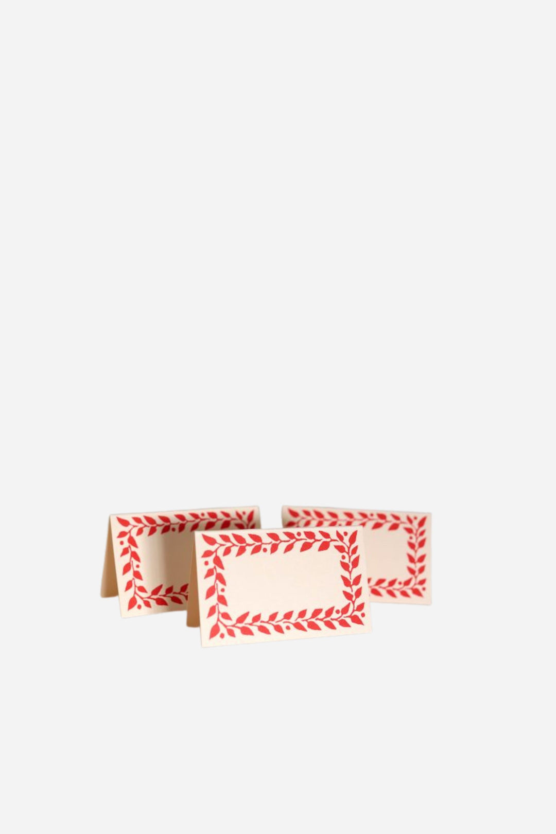 Two folded paper cards with red patterns on a white background