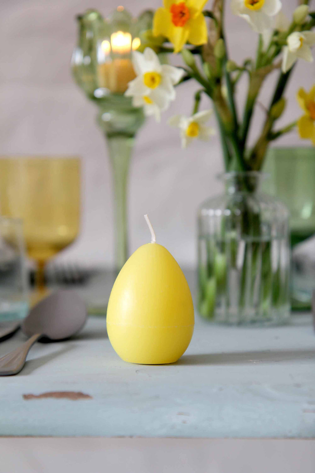 yellow egg candle on easter table