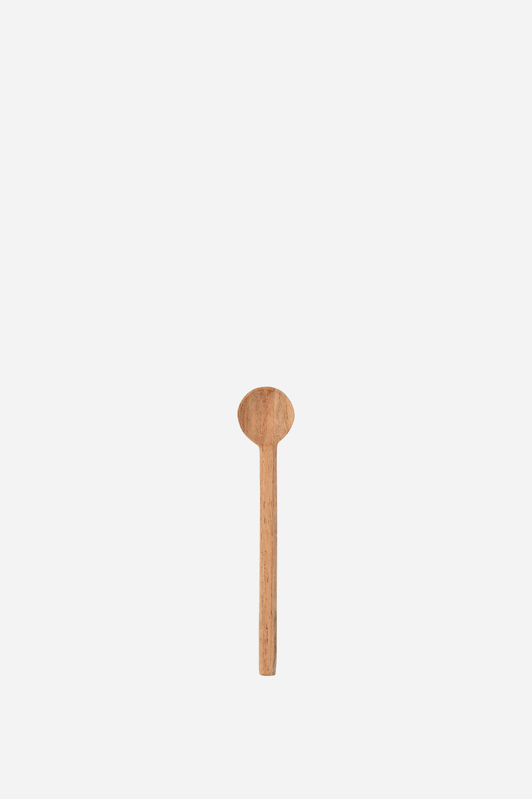 Wooden spoon on a light beige background