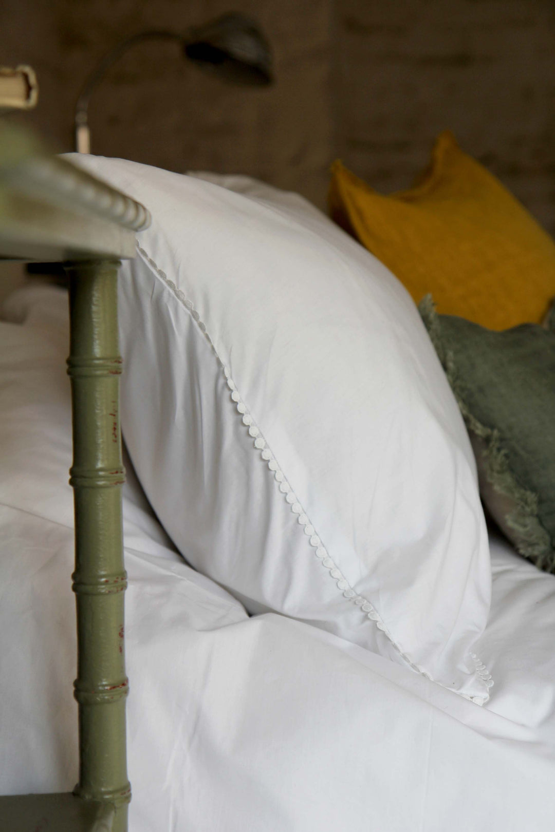 detail of white bobble pillowcase on bed