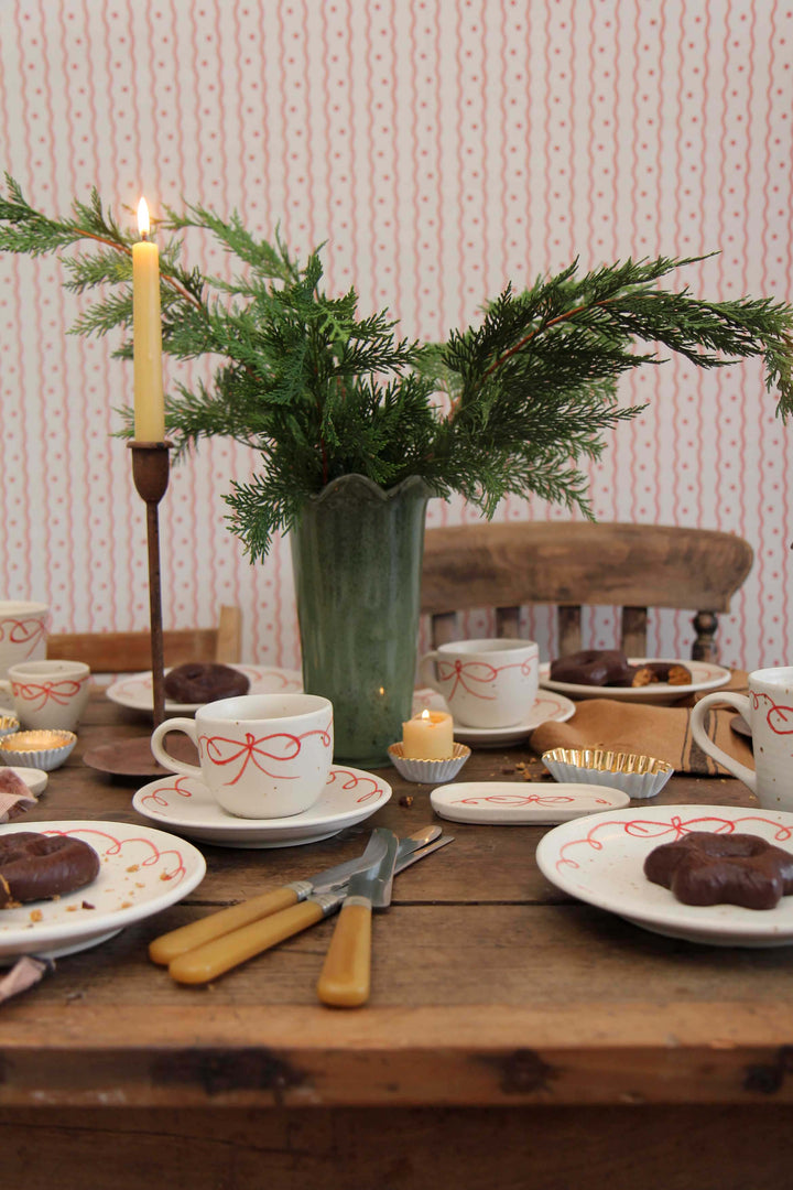 milla tall green glass vase with wavy rim on winter table