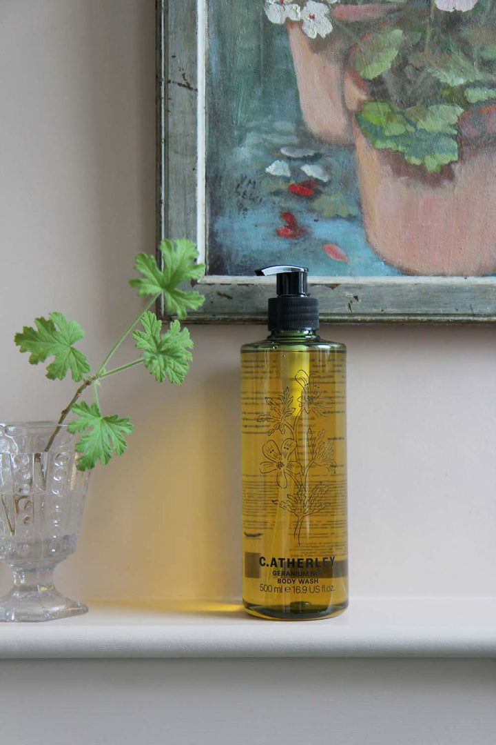 c.atherley geranium body wash in green bottle with pump in pink painted bathroom