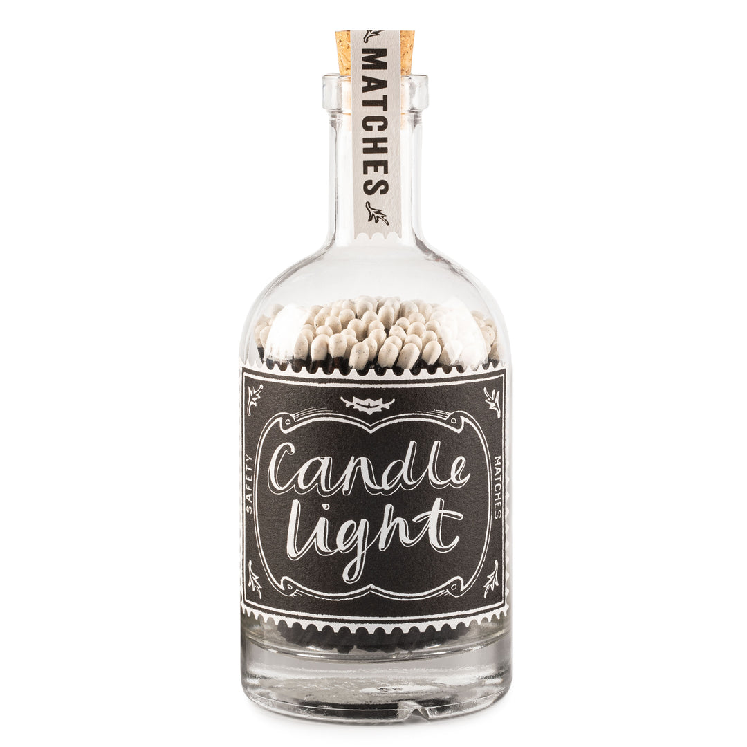 glass bottle filled with matches with decorative candle light label