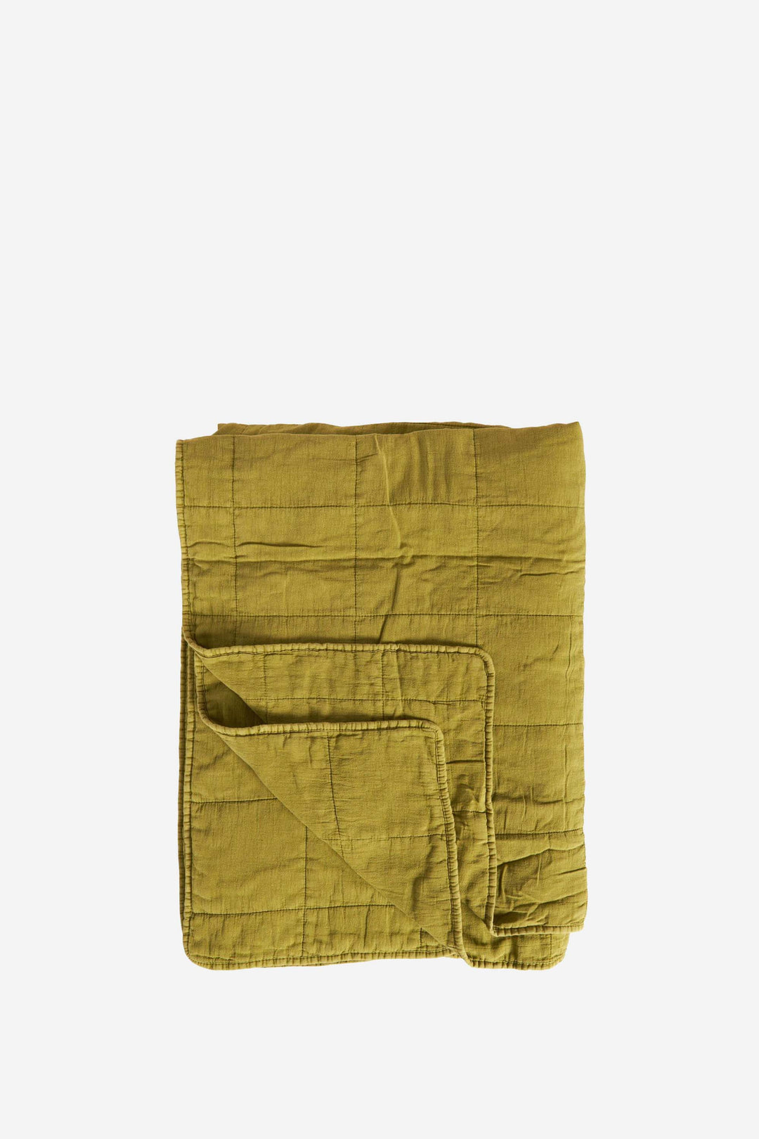Folded olive green quilt on a white background