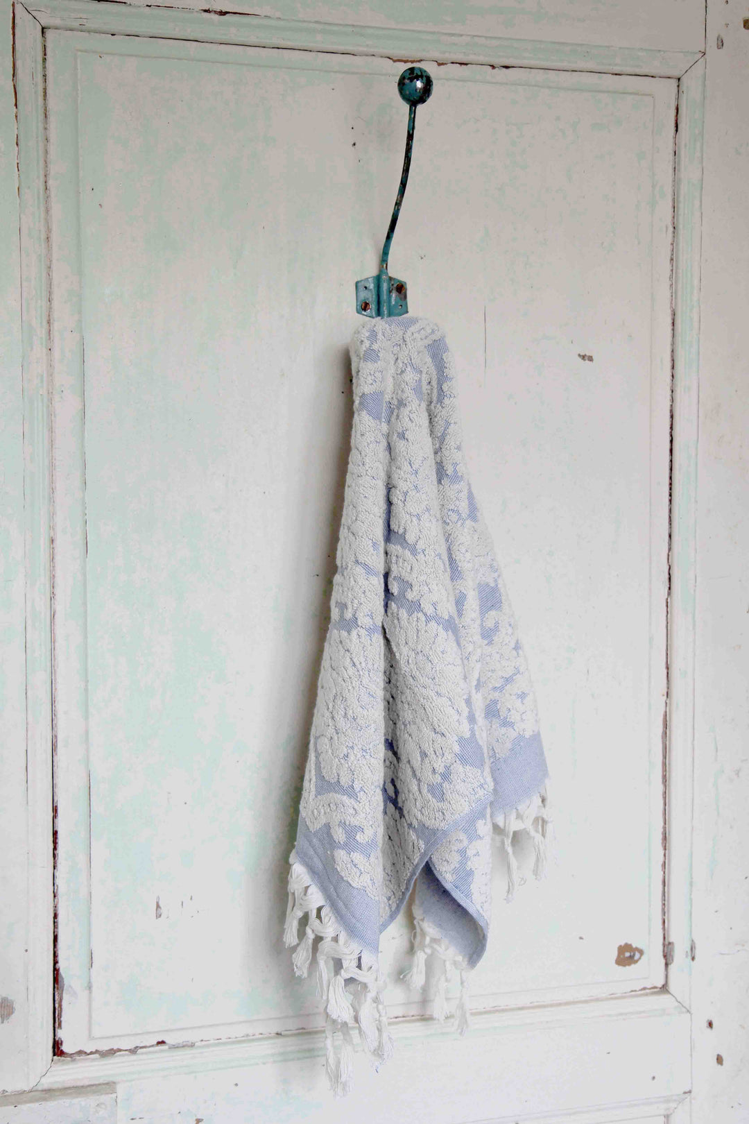 damask blue hand towel on vintage hook