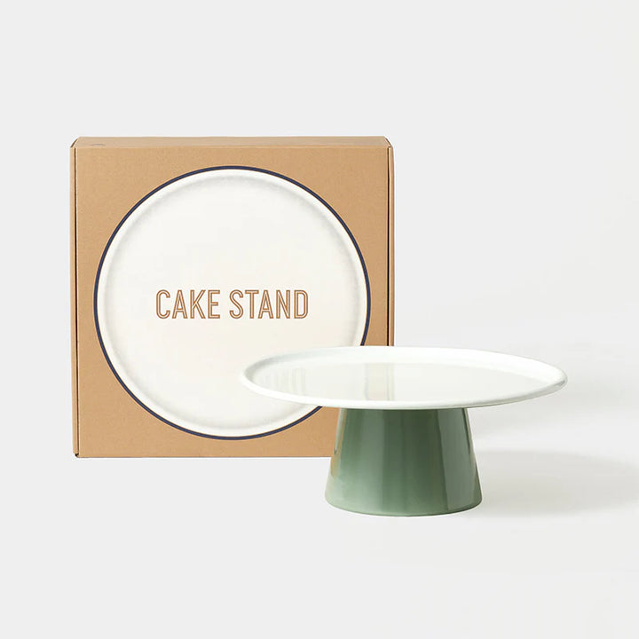 falcon enamelware Green cake stand in front of a cardboard box with 'CAKE STAND' text on a white background