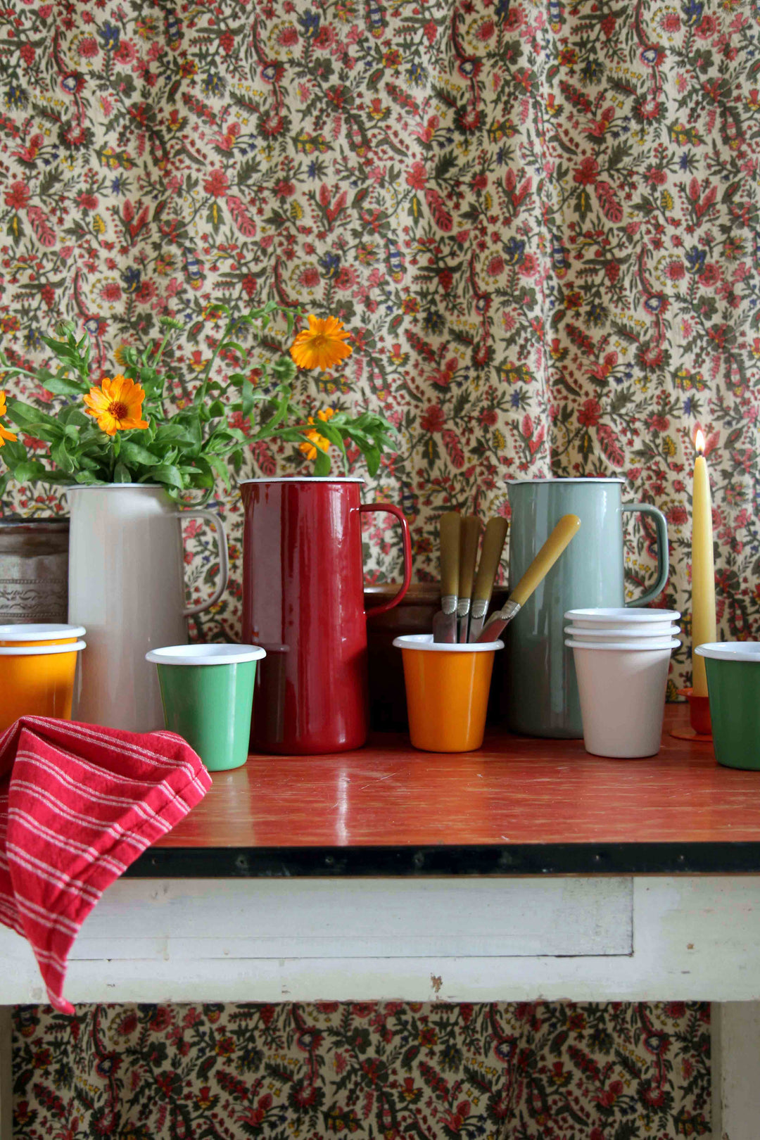 group of colourful falcon enamelware tumblers and jugs
