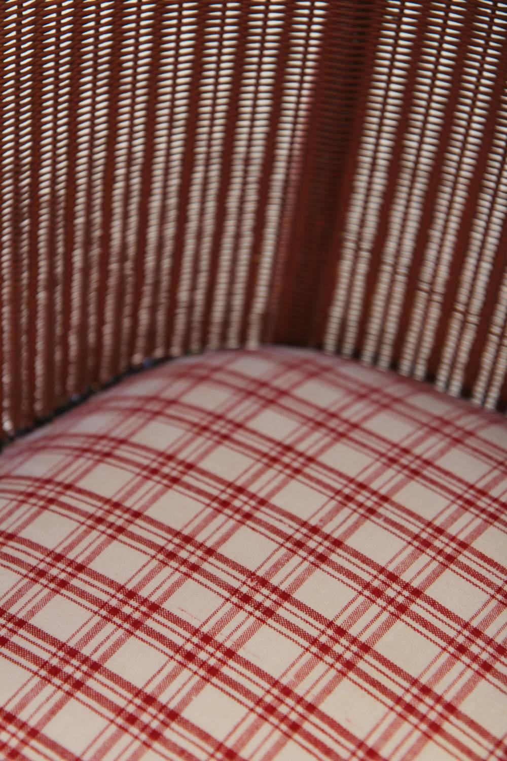 lloyd loom pink chair with red check seat
