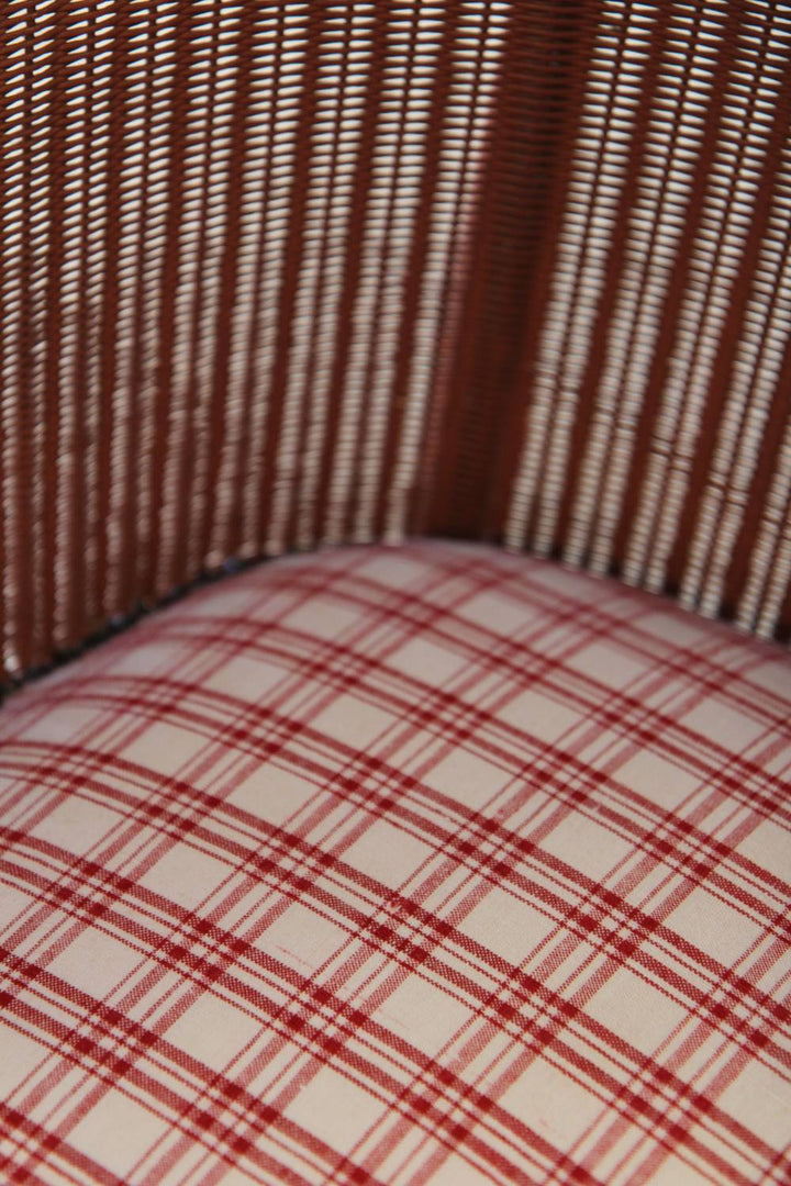 lloyd loom pink chair with red check seat