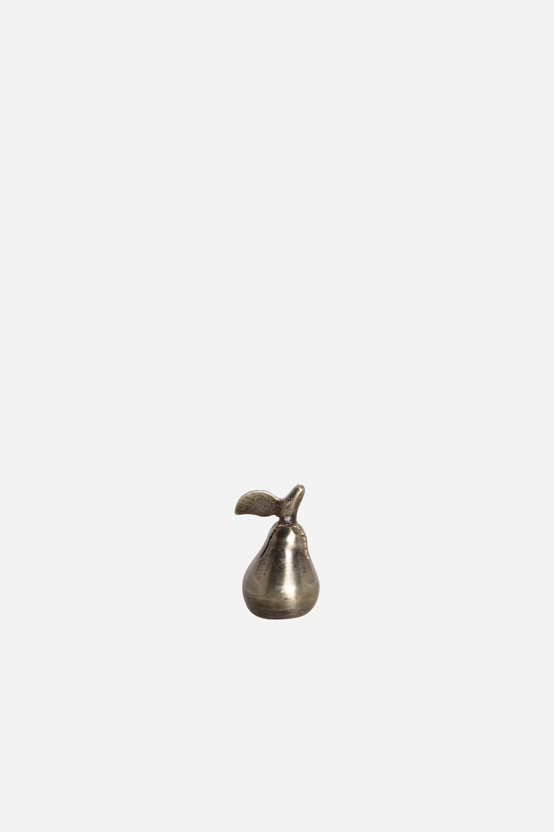 Small metallic pear-shaped object on a white background
