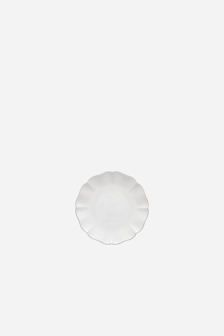 Round white appetizer plate on a white background