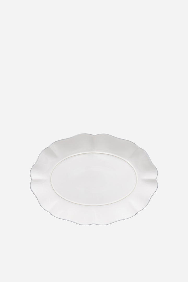 White scalloped-edge plate on a white background
