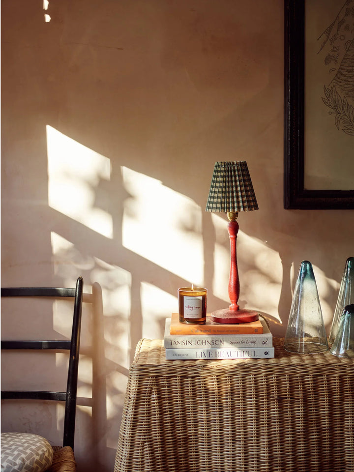 Candle Sitting Room Sandalwood and Fern on stack of books with table lamp