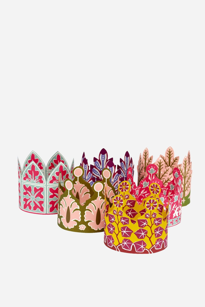 Set of colorful paper crowns on a white background
