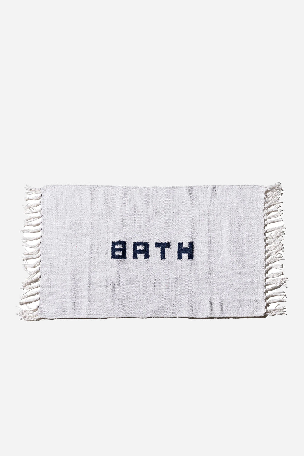 Puebco white woven bath mat with word bath woven in navy
