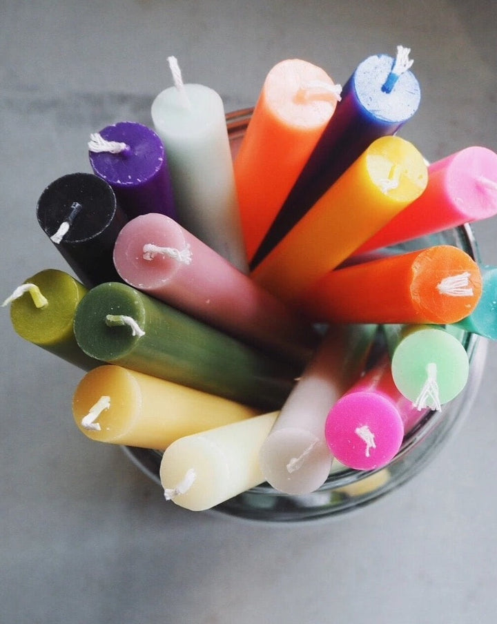 group-shot-of-a-bundle-of-brightly-coloured-dinner-candles-in-a-glass-jar-available-from-domestic-science-home