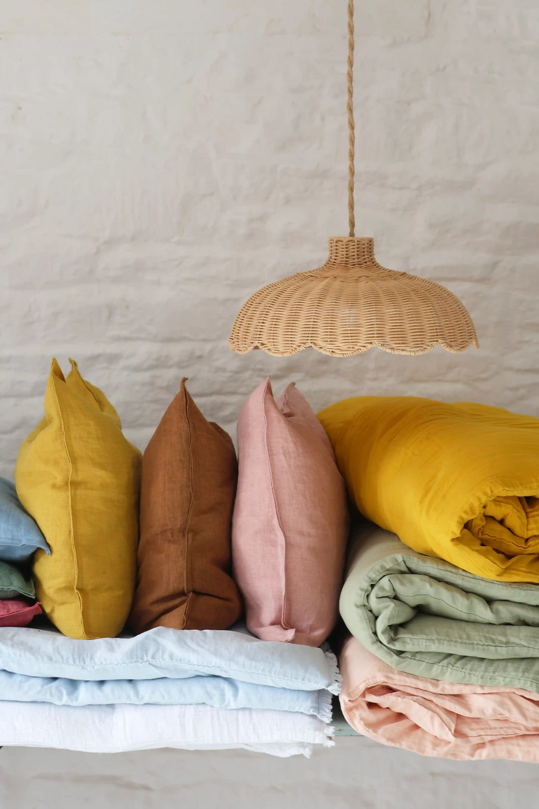 domestic science home soft furnishing, cushions and quilts in yellow ochre, pink, blue and greens