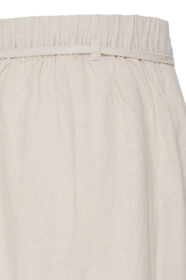 Close-up of a beige skirt with a belt on a white background
