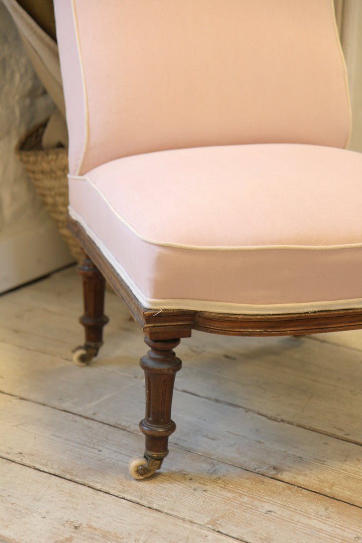 vintage nursing chair upholstered in pink fabric