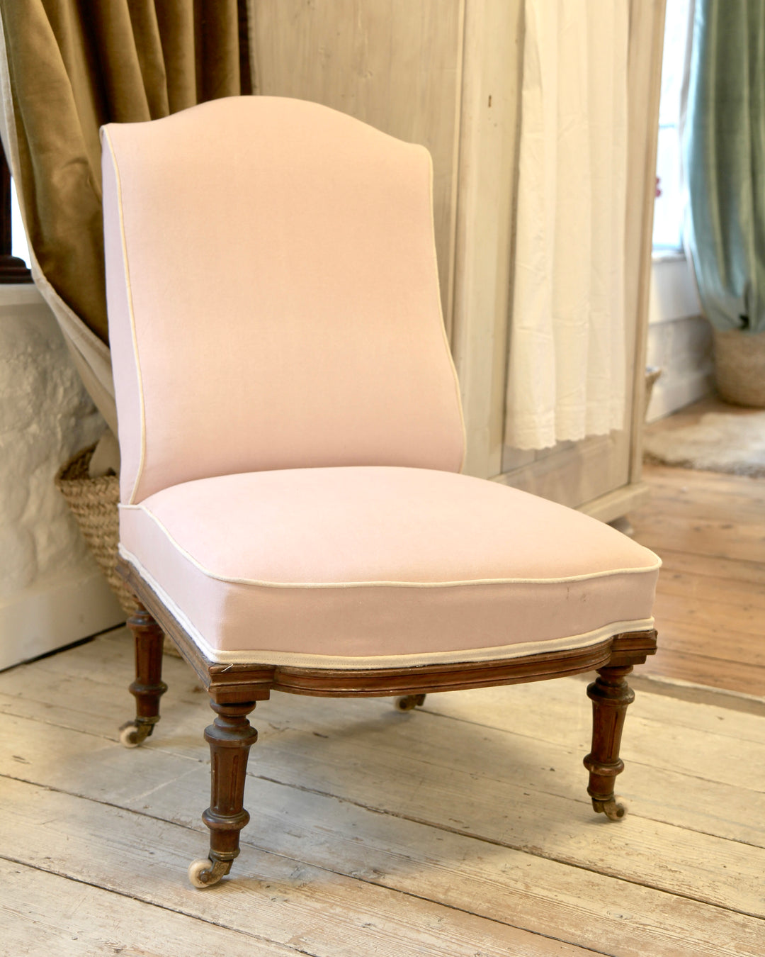 vintage nursing chair upholstered in pink fabric