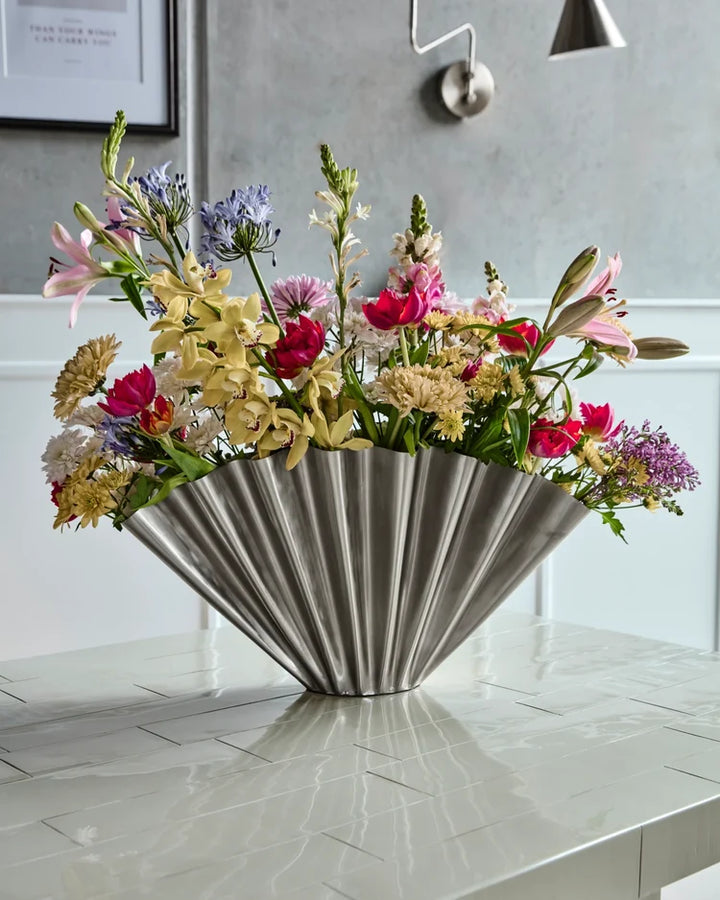 Decorative metal fan vase with colourful flowers 
