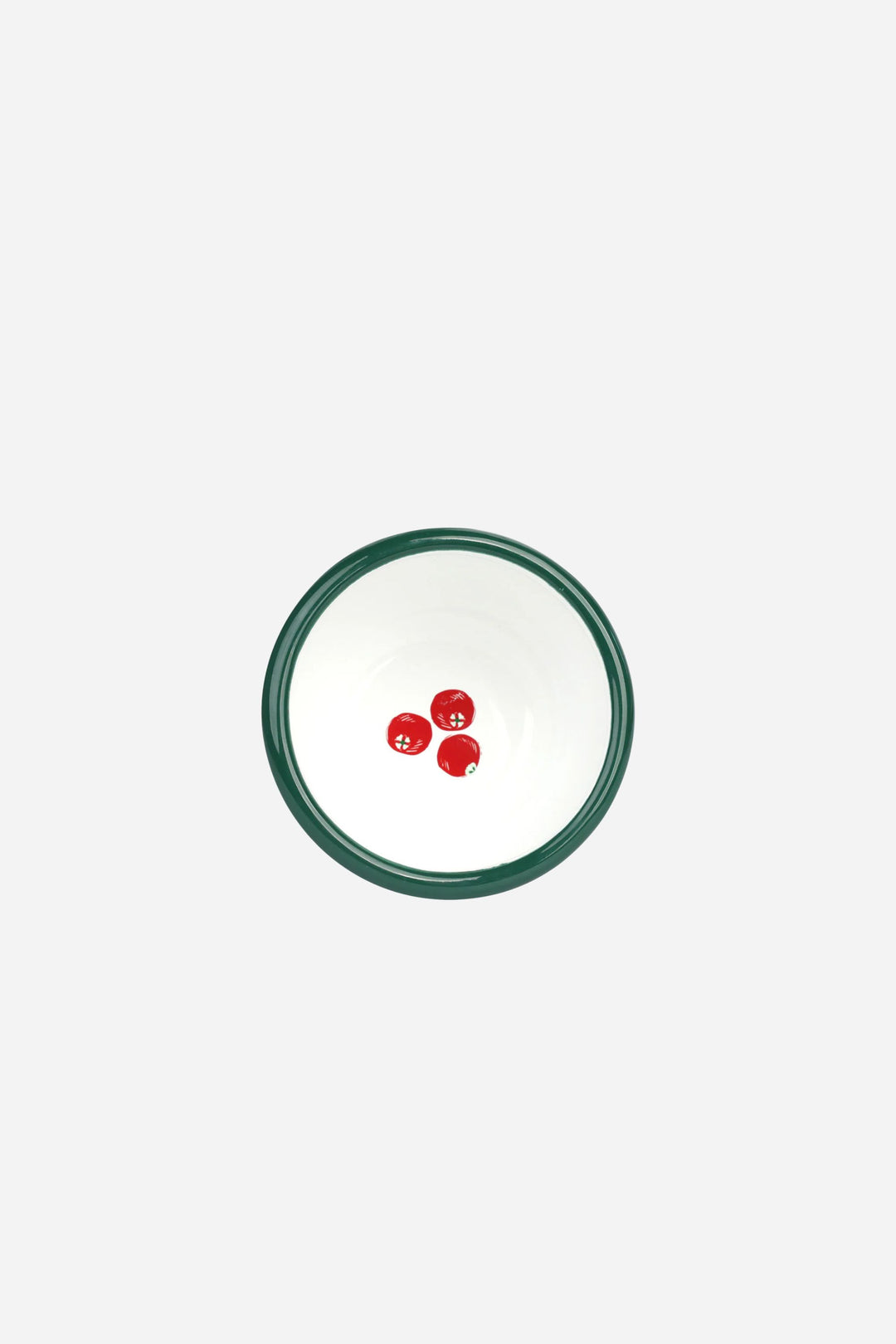 Small round white plate with a green rim featuring three red cherry-like decorations on a white background