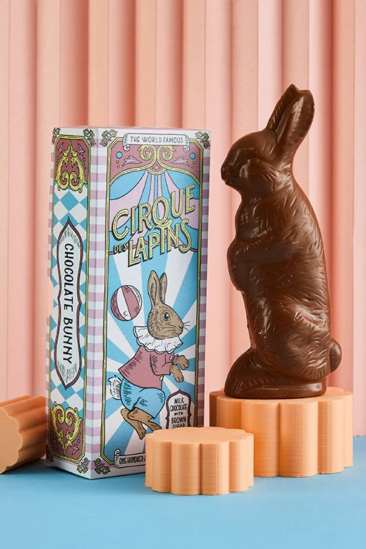 Chocolate bunny with packaging on a pink and blue background