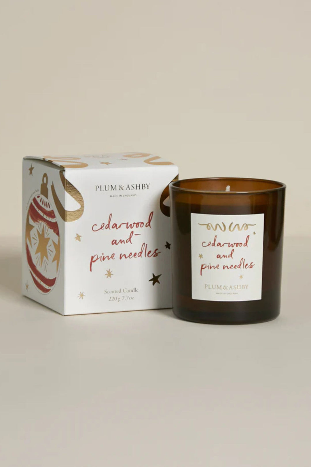 Candle with a label and packaging on a neutral background