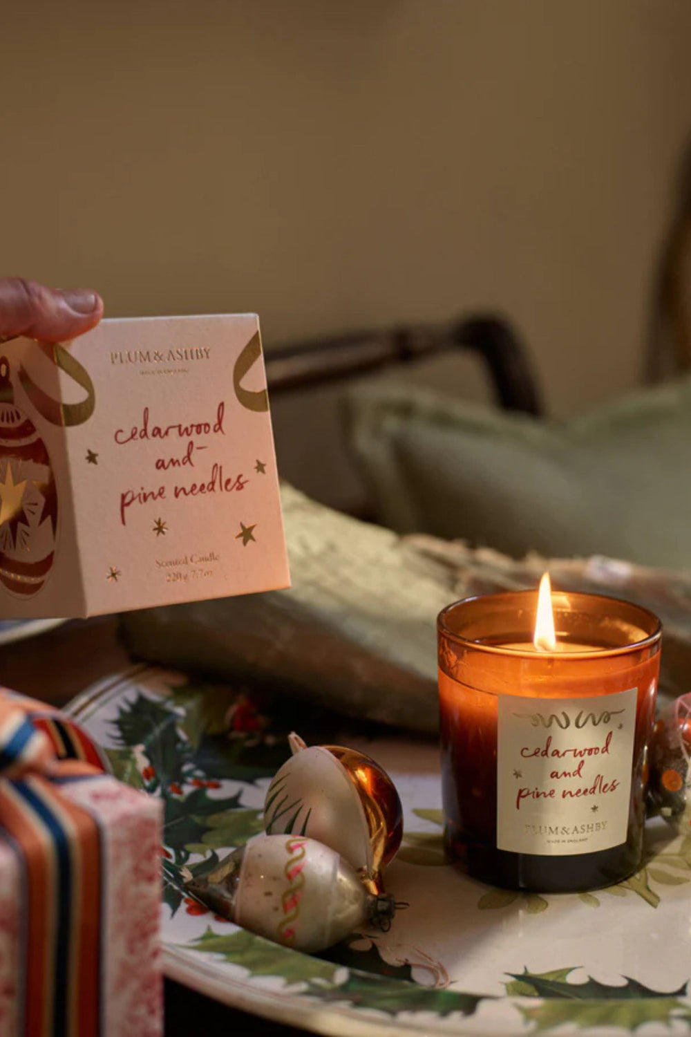 Candle with a label on a table next to a decorative card