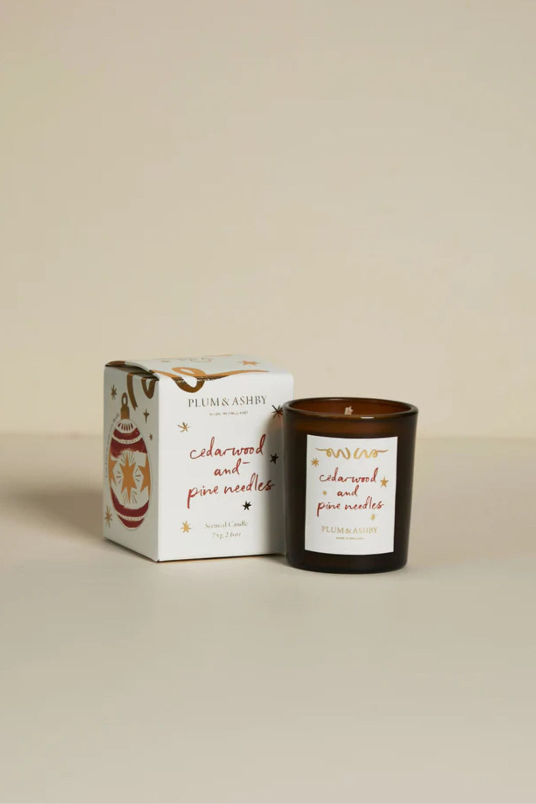 Candle and packaging with 'Plum & Ashby' branding on a beige background