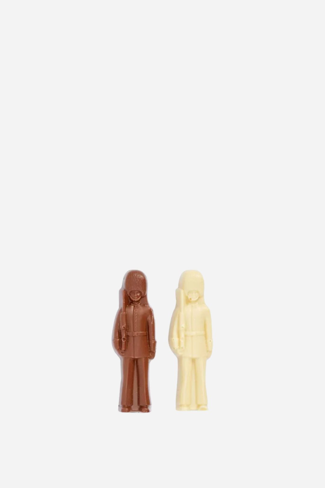 Two figurines, one brown and one beige, standing side by side on a white background.