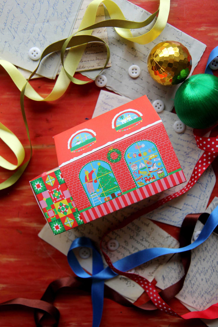 Colorful matches with festive design on a wooden surface with ribbons and ornaments.