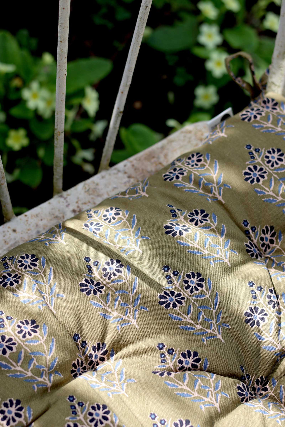 Close-up of a floral-patterned fabric with a blurred natural background