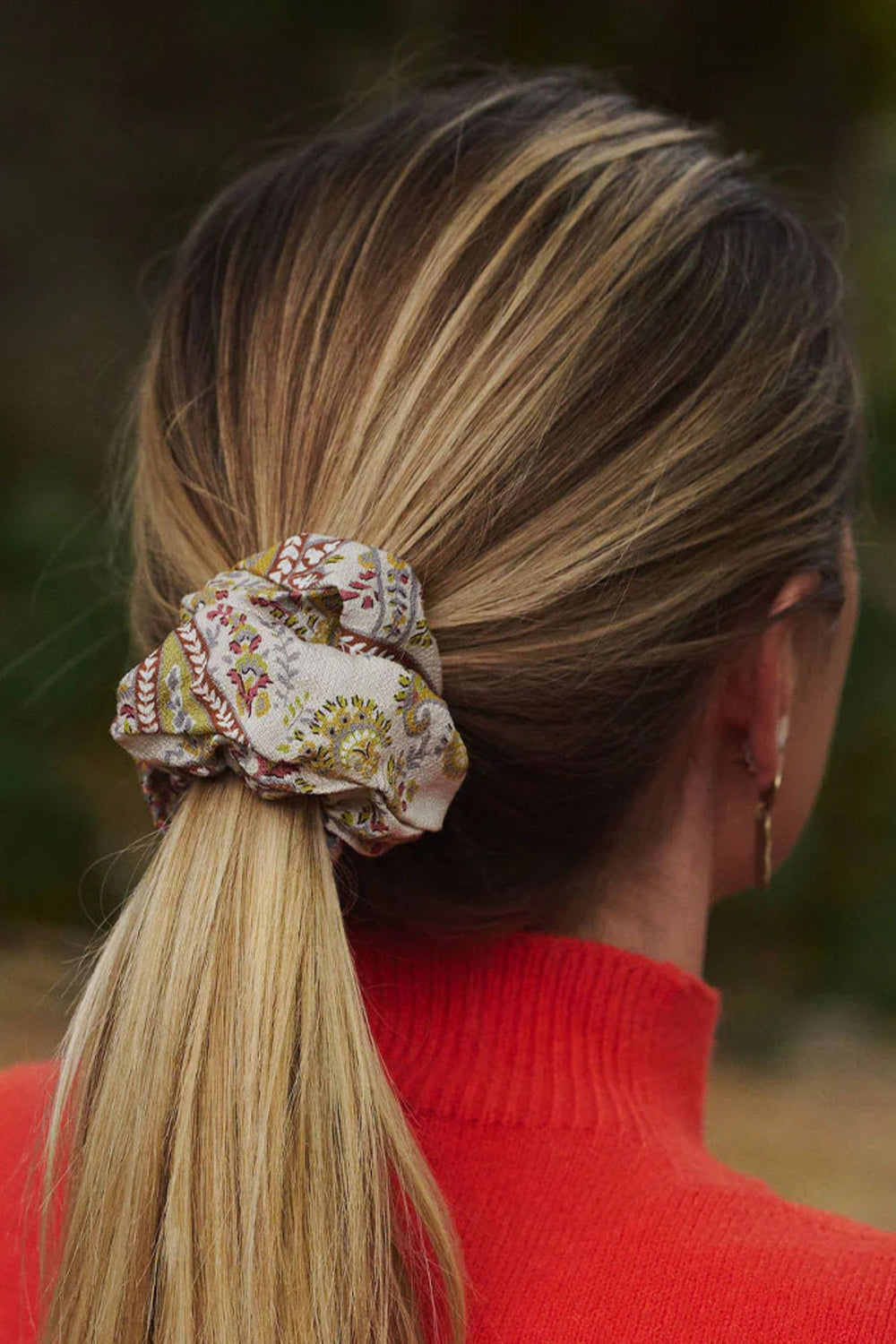back of womans head with floral scrunchie