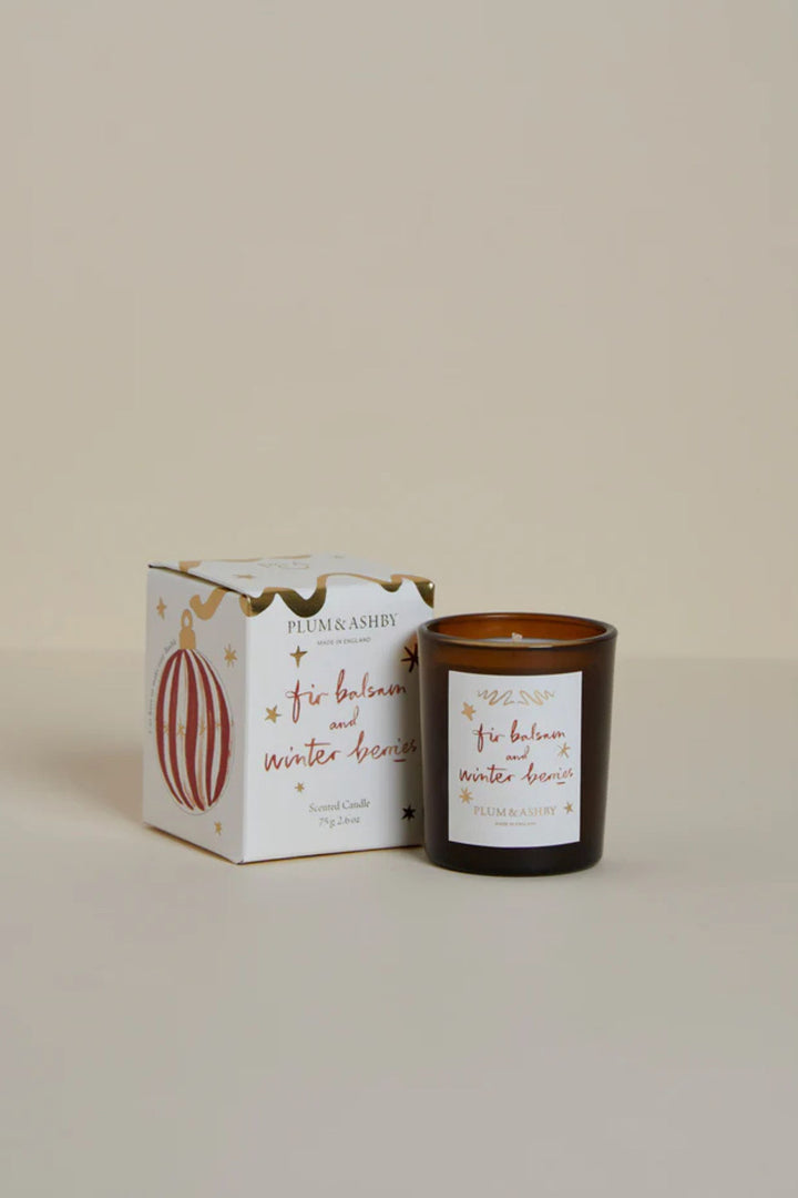 Candle and packaging with decorative elements on a beige background