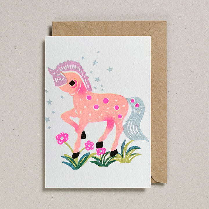 Greeting card with a pink horse illustration on a white background, featuring a brown envelope.