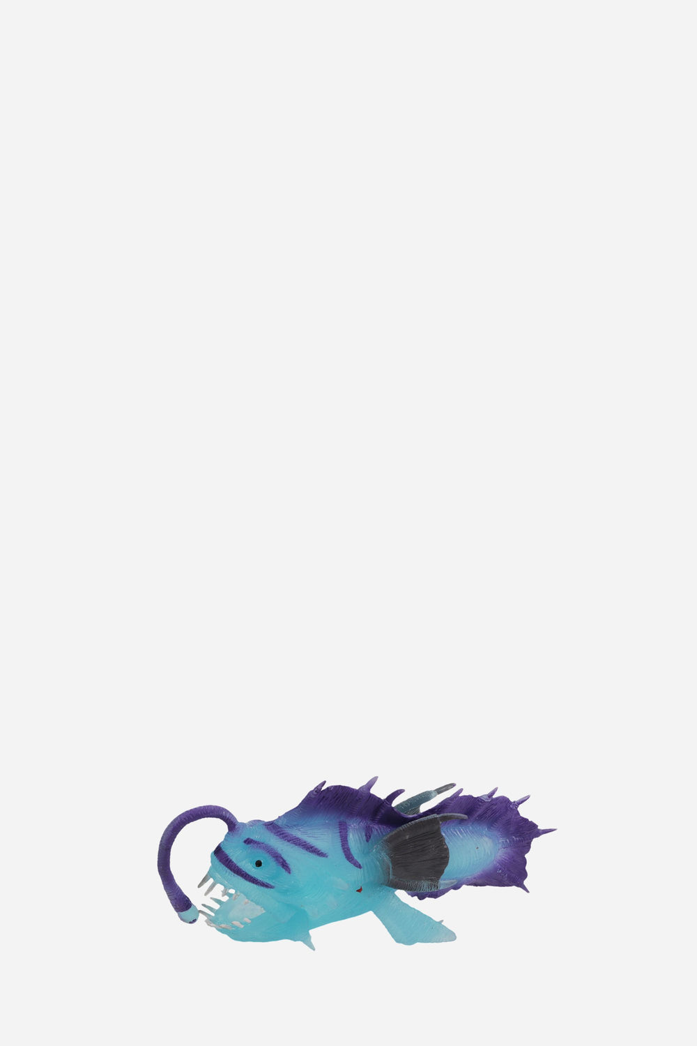 Toy figure of a blue and purple creature on a white background