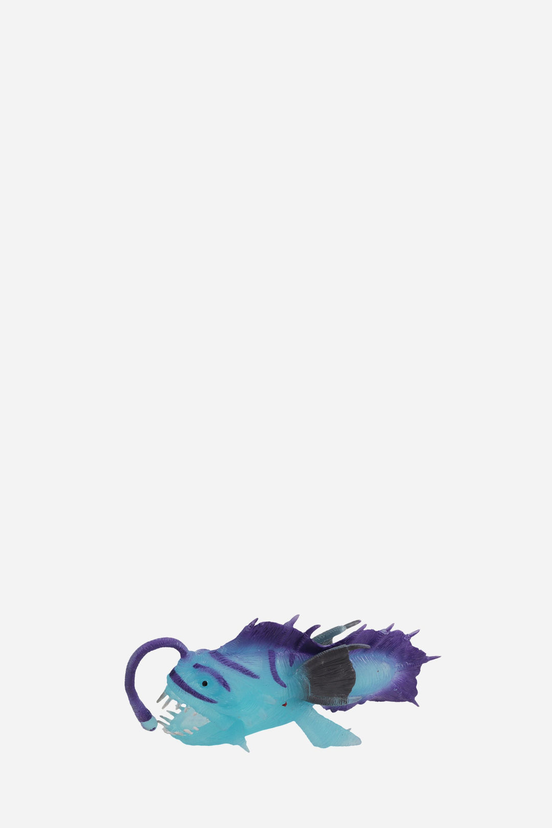Toy figure of a blue and purple creature on a white background