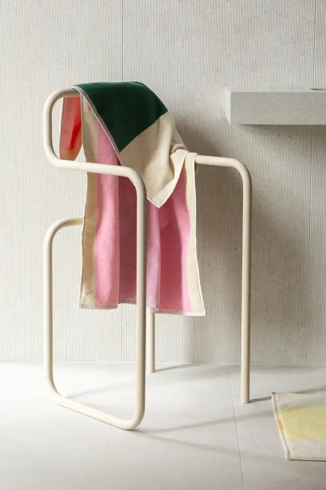 Towel rack with a colorful towel on a neutral background