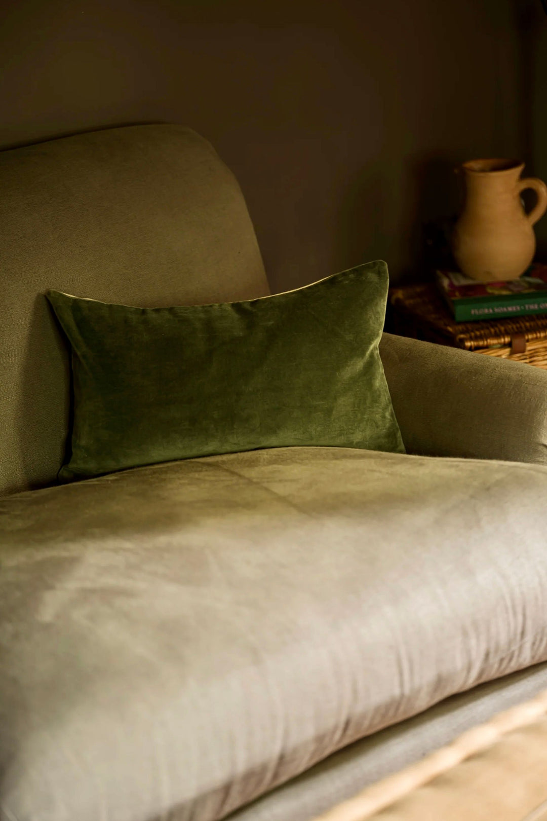 green cushion on grey sofa